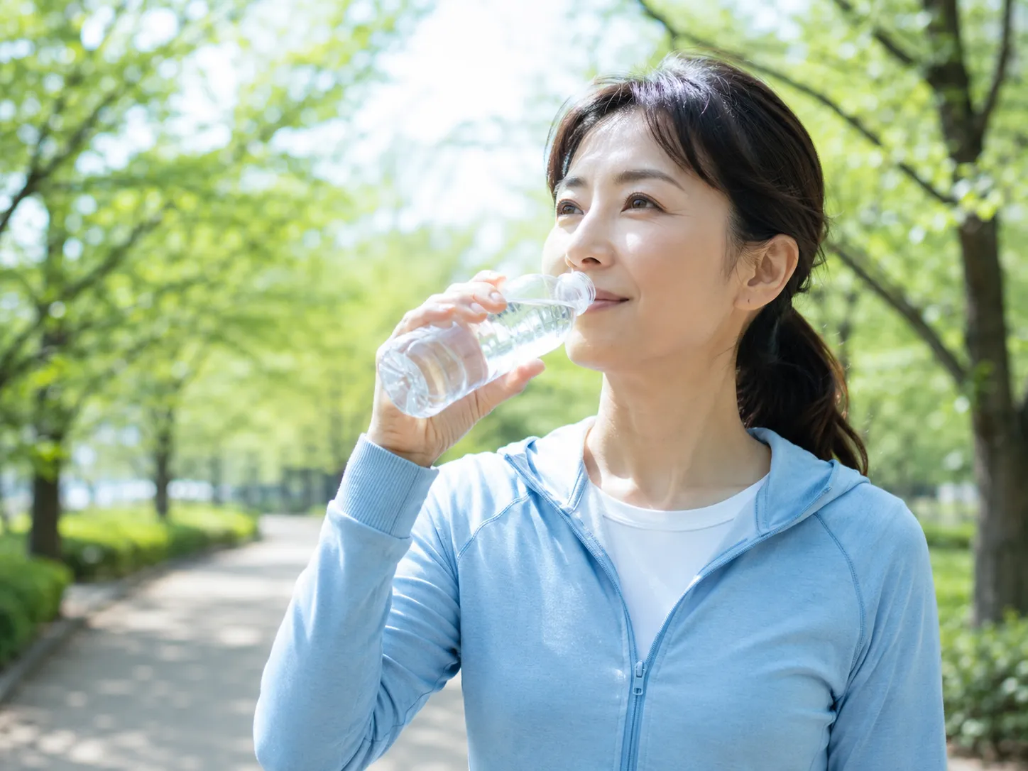 疲労回復の為に運動後に水分補給をする女性